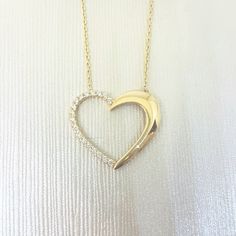 - Forever Love Heart Pendant Necklace is made with high quality 14K real solid gold. - High polish finish and half of the heart necklace for women decoreted with white diamond cut zirconia stones . - This cute, charm, dainty, delicate, elegant and trendy women jewelry Heart pendant necklace has been artfully designed for timeless yet modern millennial fashion. - You receive the necklace in a beautiful and free gift box - Free shipping (Arrive within 4 business days to the USA and Canada ( 1 day White Open Heart Diamond Necklace, White Heart Necklace For Anniversary Gift, White Heart Shaped Necklace For Anniversary, White Heart-shaped Necklace For Anniversary, Millennial Fashion, Snowflake Bracelet, Dainty Gold Bracelet, Necklace With Heart, Open Heart Necklace