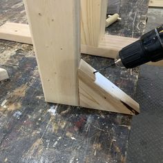 a drill is being used to fix a piece of wood that has been placed on the floor