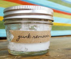 a jar filled with white sugar sitting on top of a wooden table