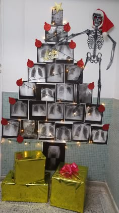 a christmas tree made out of photos and wrapped presents in front of a skeleton wall