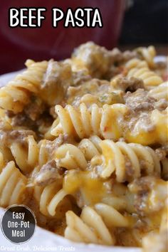 a close up of a plate of food with pasta and meat in sauce on it