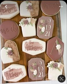 decorated cookies with wedding date and names on them are arranged on a wooden table top