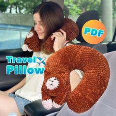 a woman sitting in the back seat of a car with a stuffed animal on her neck