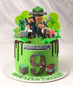 a green cake with an image of minecraft on it's top and the number nine