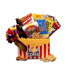 a popcorn bucket filled with movies, snacks and candy bars to be eaten for the movie night