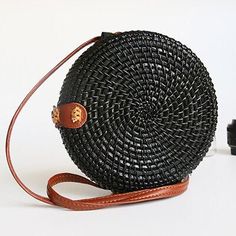 Through some creative minds, the raw material is modified into many beautiful bag creations.This round rattan bag can give your look an extra breath of boho and elegance by referring to nature, with a long leather strap and a brass buckle closure. It's made with natural rattan fabric. A memorable gift for any woman a must-have straw purse for every fashionista. Whether you keeping it to yourself or gifting someone you care about. Simple design and unique style, you can be used for your daily lif Brown Braided Rattan Shoulder Bag, Daily Use Braided Rattan Shoulder Bag, Chic Rattan Shoulder Bag With Adjustable Strap, Bohemian Rattan Shoulder Bag With Braided Handles, Bohemian Rattan Shoulder Bag For Daily Use, Bohemian Rattan Straw Bag With Adjustable Strap, Chic Rattan Straw Bag With Adjustable Strap, Black Bag With Round Handle For Summer, Summer Black Shoulder Bag With Round Handle