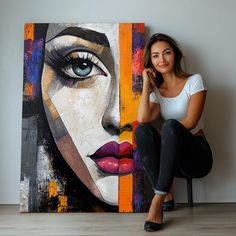 a woman sitting on a chair next to a painting with blue eyes and red lips