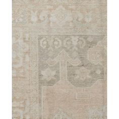 an antique rug with various colors and patterns on the carpet, including beiges and browns