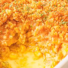 a casserole dish with corn and cheese on top, ready to be eaten