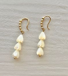 This Beautiful Mother of Pearl Carved Pikake Hawaiian Jasmine Flower Island Style Natural golden Mother of Pearl high quality beads on Gold Plated fish hook earrings.  Earrings are light weight and great to wear everyday.  Your pair of earrings will come in a gift box then placed into a mailing envelope.  PLEASE READ BEFORE PLACING YOUR ORDER: FREE SHIPPING FOR ORDERS OVER $35.00 Offer ONLY Eligible in the United States. I ship my packages USPS First Class and provide the tracking number. NOTE: Flower Island, Purple Lotus, Jasmine Flower, Photo Box, Fish Hook Earrings, Island Style, Gold Plated Earrings, Fish Hook, Hook Earrings