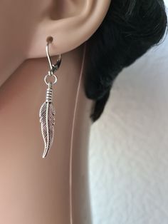 Single feather earring, Feather dangle, Men earring, Symbolic meaning, Silver feather, Silver earring, Gold feather, Gunmetal feather ,for him Earring with lever back hook length 2Inches ( 50 mm ) Charm length 32 mm Earrings are really lightweight and comfortable to wear. Adjustable Dangle Feather Jewelry, Adjustable Silver Feather Earrings, Feathered Dangle Jewelry As A Gift, Dangle Feather Jewelry As A Gift, Adjustable Silver Earrings With Feathers, Feather Earrings Silver, Gold Feathers, Earring Gold, Silver Feather