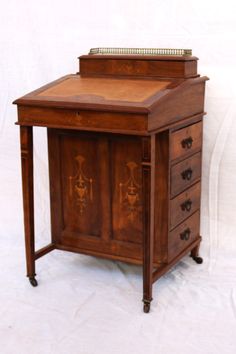 an old wooden desk with drawers on it