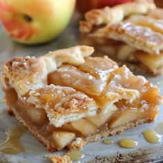 two pieces of apple pie sitting on top of a plate