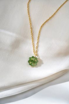 Jade Gemstone Necklace, Dainty Gold Filled Necklace Luck around your neck! With green jade and a lucky four leaf clover design, this necklace features a double dose of good fortune! Jade is believed to bring good luck, and the shamrock has been a Celtic symbol of fortune for centuries! DETAILS: - Natural green nephrite jade gemstone pendant - Carved by hand - 14k gold filled chain, spring clasp closure - Gemstone pendant: 13mm - Choose your desired length *Gemstones are natural and may slightly Green Necklaces With Clavicle Chain And Flower Pendant, Green Jewelry For Good Luck, May Birthstone, Green Gemstone Necklace For Good Luck, Jade Jewelry Necklace, Shamrock Necklace, Four Leaf Clover Charm, Lucky Necklace, Celtic Symbol, Luck Necklace