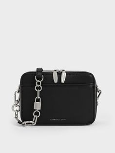 This product is made with at least 20% sustainable materials by weight. CHARLES & KEITH uses recycled, degradable, organic, and water-based materials in our eco-conscious collection. Look no further than this chain handle bag for the perfect blend of casual and elevated. Keeping it simple and sleek with a black finish and rectangular silhouette, this accessory is a breeze to style and will go well with most outfits. To add subtle visual interest, a lock and key motif bearing the CHARLES & KEITH logo has been incorporated into the chain handle to elevate the classic bag style. Complete with a zip closure that keeps your belongings secure and an adjustable strap that offers multiple carrying options, this bag is functional with a modern twist. Keeping It Simple, Brand Collaboration, Charts For Kids, Size Chart For Kids, Locks & Key, Classic Bags, Charles Keith, Lock And Key, Luggage Accessories