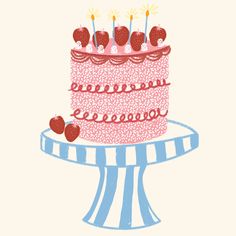 a birthday cake with candles and strawberries on top is sitting on a blue striped pedestal