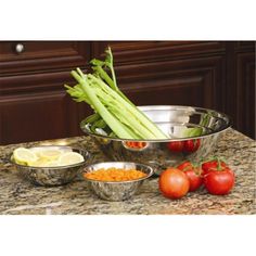 several different types of vegetables in bowls on a counter