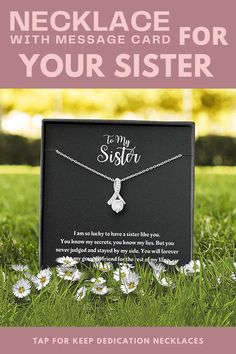 a card that says, necklace with message for your sister on it in front of daisies