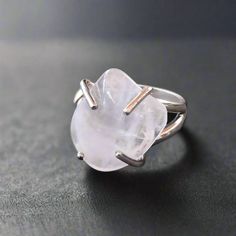 Bring warmth and love into your life with this beautiful Rose Quartz Ring featuring a tumbled stone in a prong setting in Sterling Silver. The ring fits the majority fingers being a Size 7. This beautiful ring features a tumbled rose quartz stone measuring 15mm wide by 18mm long, set in high-quality sterling silver with a prong setting. It is currently available in a US/CA size 7 and has an open back design. THE STONE: ROSE QUARTZ - heart chakra • Stone of Unconditional Love & Infinite Peace • l Rose Quartz Crystal Ring For Promise, Promise Ring With Rose Quartz And Gemstone Detail, Silver Rose Quartz Crystal Ring, December Stone, Lotus Moon, Stone Rose, Rose Quartz Heart, Lapis Lazuli Stone, Rose Quartz Ring