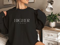 Embrace the nostalgia of 90s rock with this "HIGHER 1999" sweater, inspired by the Rock Band "Creed" iconic songs. It features bold typography and crafted for comfort, it's a must-have for fans of the era's anthemic tunes. 👕 SIZING: ➤ Please refer to sizing in the images ✈️ SHIPPING TIME: ➤  1-7 Business Days 👔 CARE INSTRUCTIONS ➤ Machine wash: Cold with like colours ➤ Non-chlorine bleach ONLY ➤ Tumble dry: low heat ➤ Medium iron ➤ Do not dry clean 📝 HOW TO ORDER 1. Select the Size 2. Select Creed Band, Band Sweater, Nostalgic 90s, 90s Sweater, Band Shirt, Women's Casual Style, Band Merch, Vintage Sweater, Band Shirts