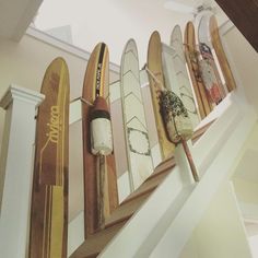 there are many surfboards hanging on the wall