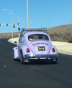 a purple beetle driving down the road