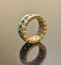 DeKara Designs Collection Metal- 18K Yellow Gold, .750. Stones- 17 Genuine Round Emeralds 1.90 Carats, 102 Round Diamonds F-G Color VS1 Clarity 0.42 Carats. Entirely Handmade 18K Yellow Gold Eternity Diamond Round Emerald Engagement Band. This band is extremely elegant featuring round fiery, and beautiful green emeralds that are all professionally burnish set individually with amazing bead work surrounding each stone. There are 51 professionally pave set round diamonds on the top and bottom of b Luxury Moissanite Wedding Ring, Luxury Cubic Zirconia Bridal Set For Anniversary, Luxury Diamond Bridal Sets, Emerald Wedding Jewelry With Pave Setting, Luxury Emerald Wedding Ring For Anniversary, Luxury Moissanite Jewelry For Marriage, Luxury Hand Set Bridal Sets, Luxury Hand Set Bridal Sets For Wedding, Luxury Wedding Bridal Sets