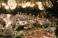 an elegant wedding reception with chandeliers hanging from the ceiling