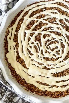 a cake with white frosting on top in a bowl