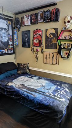 a bedroom with posters on the wall and a bed covered in blue plastic sheeting