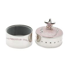 a white and pink box with a star decoration on the lid, next to it's holder