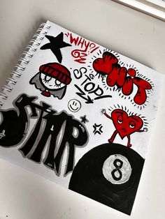 a spiral notebook with stickers on it