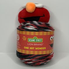 the sesame street lion brand one hat wonder yarn is red and black with white stripes