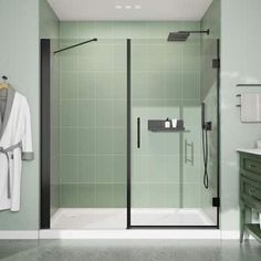 a bathroom with green walls and tile flooring, including a walk - in shower