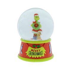 a snow globe with an image of a christmas tree in the center and santa's hat on top