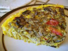 a slice of quiche with mushrooms and tomatoes on a plate