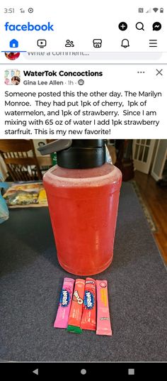 a pink drink sitting on top of a table next to some candy bar wrappers