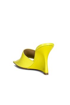 Find BOTTEGA VENETA Stretch Mule Wedges In Yellow on Editorialist. Bottega Veneta Stretch Mule Wedges in Yellow Leather upper with rubber-injected leather sole. Made in Italy. Leather lining with debossed Bottega Veneta logo detail. Square toe. Approx 89mm/ 3.5 inch wedge. BOTT-WZ318. 690024 VBSF0 7278. About the designer: Bottega Veneta – inspiring individuality with innovative craftmanship since 1966. Creativity lies at the heart of all that we do. Born in Vicenza the house is rooted in Italian culture yet maintains a truly global outlook. An inclusive brand with exclusive products Bottega Veneta is as much of a feeling as it is an aesthetic. Fitted Leather Sandals With Sculpted Heel, Luxury Fitted Sandals With Deep Heel Cup, Yellow Leather Sandals With Padded Heel, Yellow Leather Sandals With Pointed Toe, Yellow Leather Pointed Toe Sandals, Designer Yellow Leather Sandals, Luxury Yellow Leather Sandals, Fitted Leather Sandals With Padded Heel, Yellow Leather Heels With Sculpted Heel