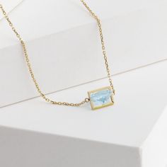 Description 10k yellow gold triangle aquamarine necklace, set in Januka's proprietary band setting. This beautiful light blue aquamarine sparkles like a lake's surface on a sunny day. Dainty and sophisticated for any occasions, whether it is business or casual. This necklace has a silicon adjuster at the back which allows you to shorten it to the length you desire to fit your look of the day.Band collection from Januka uses their proprietary setting method which tactfully carves each stone, so t Light Blue 14k Gold Jewelry For Formal Occasions, Formal Light Blue 14k Gold Jewelry, Light Blue 14k Gold Formal Jewelry, Light Blue Fine Jewelry Necklace For Formal Occasions, Light Blue Fine Jewelry Necklace For Formal Events, Minimalist Blue Topaz Jewelry For Formal Occasions, Minimalist Blue Topaz Formal Jewelry, Fine Jewelry Light Blue Gemstone Necklace, Yellow Gold Blue Topaz Necklaces With Diamond Cut