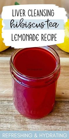 a jar filled with lemonade sitting on top of a wooden table