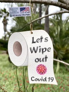 a sign that says let's wipe out covidd 19 hanging from a tree