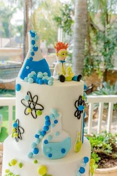 a white cake with blue and green decorations