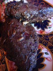 two pieces of chocolate cake sitting on top of a plate