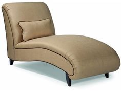 a beige chaise lounge chair with pillows on it's back and arms, viewed from the side