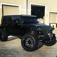 a black jeep parked in front of a building