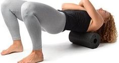 a woman is doing an exercise with a foam roller