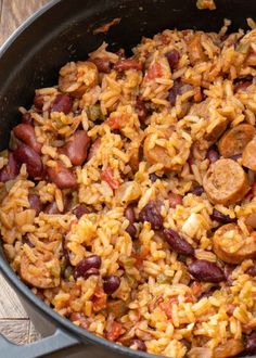 a pot filled with rice and beans on top of a wooden table