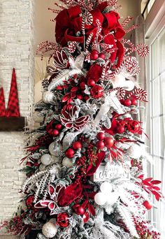 a christmas tree decorated with red and silver ornaments