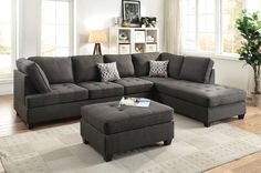 a living room with a sectional couch and ottoman