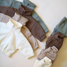 Keep your little one snug and stylish in this 2-piece sweatshirt and jogger set. Available in 4 cozy, neutral colors, this set is perfect for everyday wear during cooler months. Features: Made from soft and warm fleece material Half-zip sweatshirt with an elasticated hem and cuffs for a comfortable fit Matching joggers with an elastic waistband and cuffs for easy movement Available in four versatile colors: Cream, Sage, Mocha, and Slate Perfect for layering, lounging, or outdoor play Machine was Baby Boy Fits, Baby Neutral Clothes, Neutral Clothing, Baby Boy Clothing, Newborn Clothing, Neutral Baby Clothes, Toddler Accessories, Toddler Clothes